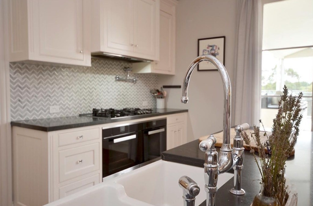 White country kitchen with chevron splashback and chrome tapware